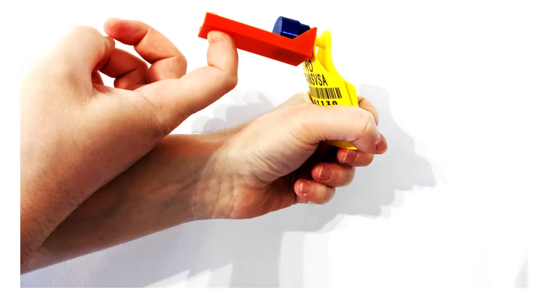 Red 3D-printed tool detaching the tag from an ear tag